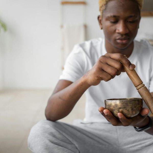 Man meditating in a calm, focused state after a workout session.